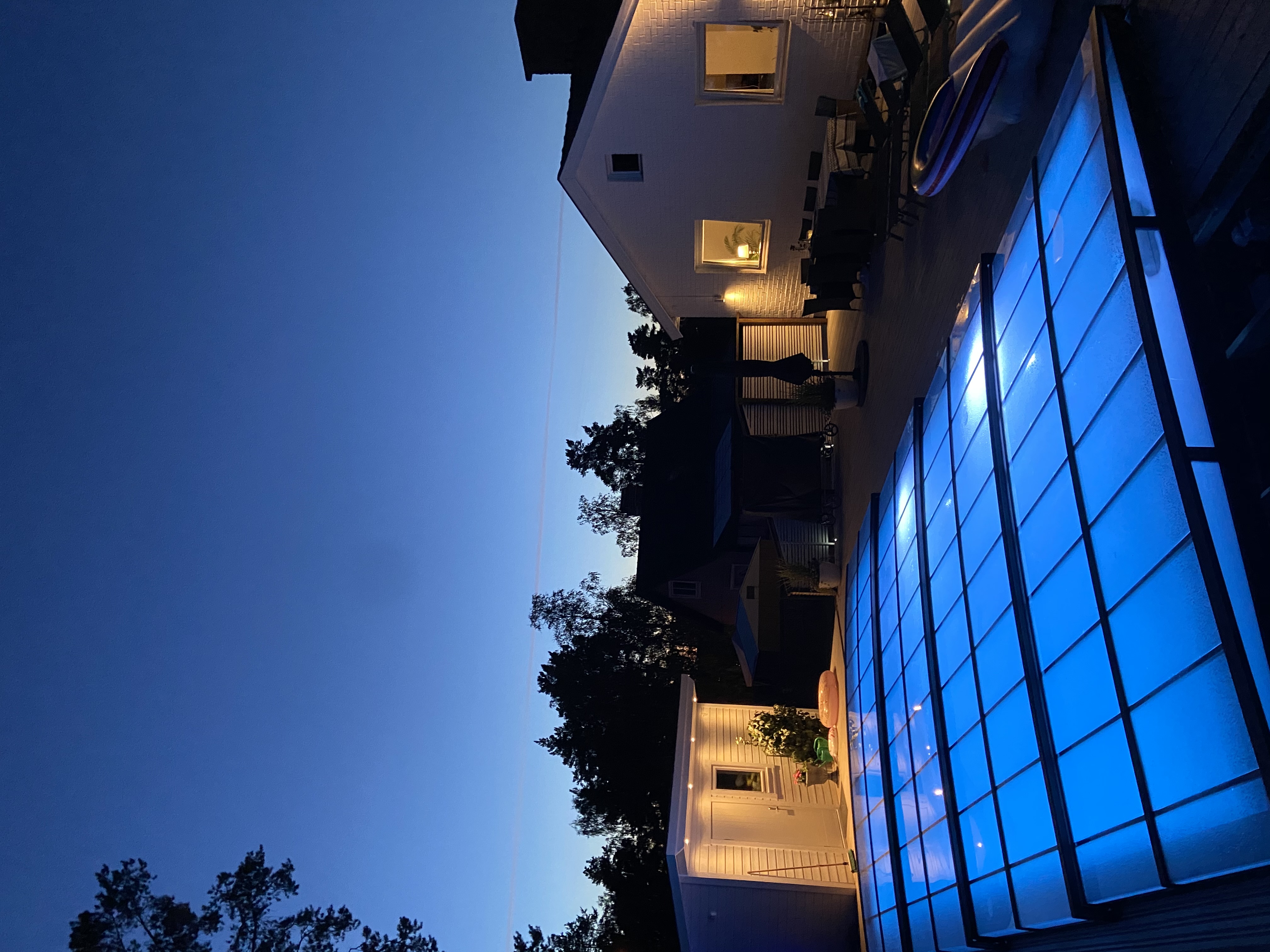 Pool med lysande glastak i blått LED-sken vid skymning – exemplifierar service och underhåll